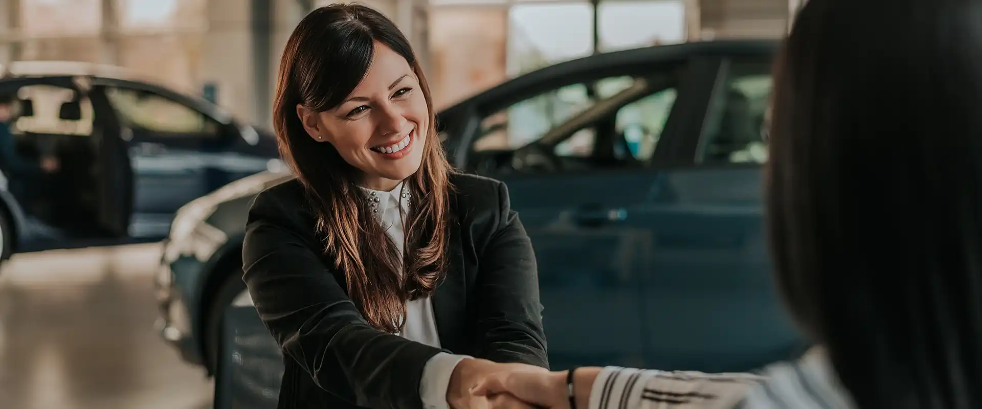 Happy dealership customer smiling during a service visit